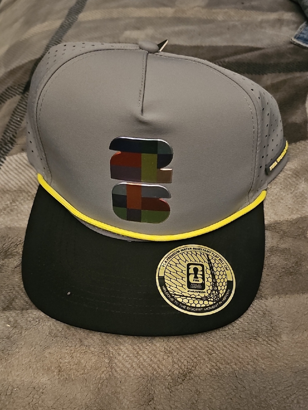FIFA 26 Gray Snapback Cap with Multicolor Logo and Yellow Trim